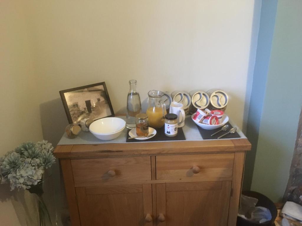 a small wooden cabinet with food on top of it at Garth Engan Private Self Contained B&B with Garden Area in Llanbedr