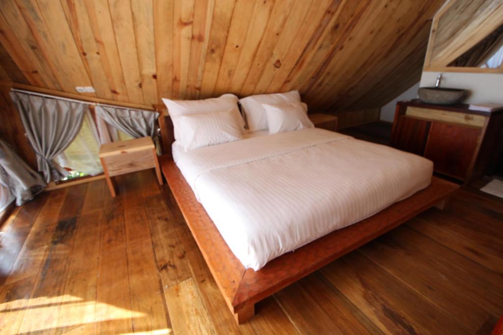 Postel nebo postele na pokoji v ubytování Padi Ecolodge
