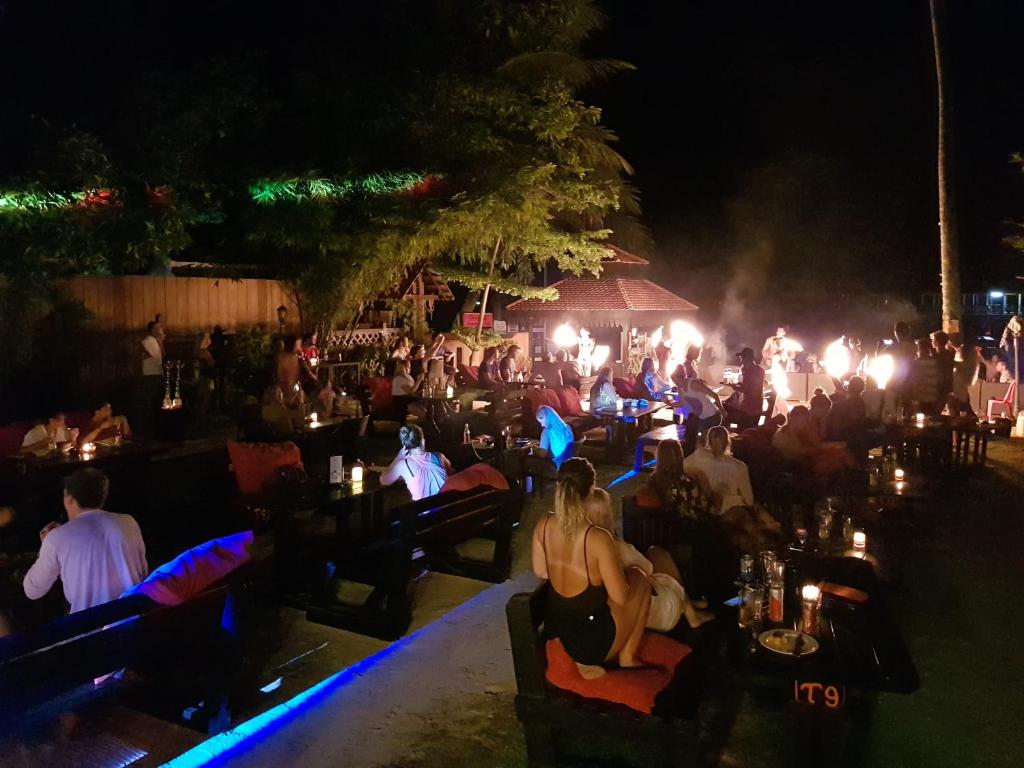 a group of people sitting at a party at night at Ombak Dive Resort Perhentian Island in Perhentian Islands