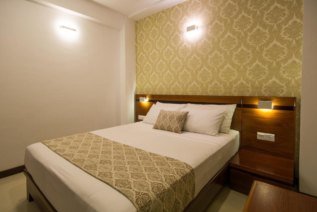 Postel nebo postele na pokoji v ubytování Ceyloni City Hotel