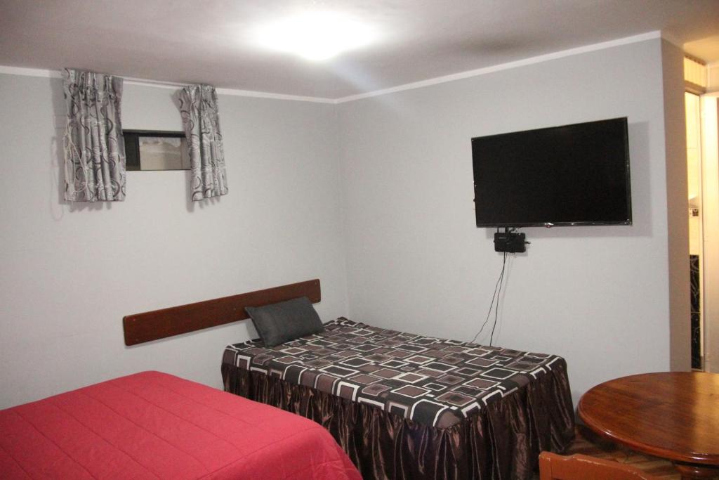 Postel nebo postele na pokoji v ubytování Hostal Florencia
