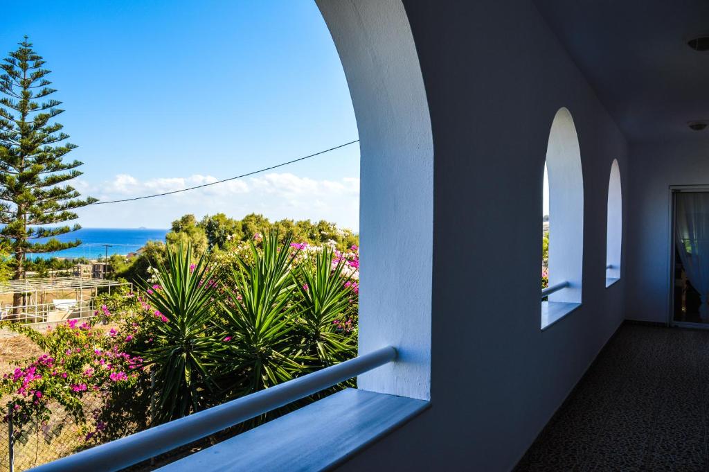 a view of the ocean from a house balcony at United blue Resorts - White Sand in Karteros