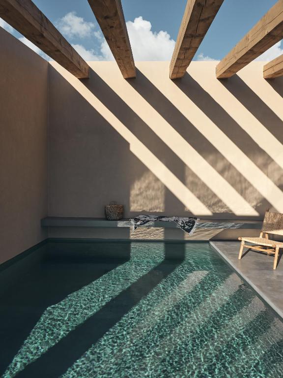 a swimming pool with a view of a house at Vais Luxury Villas in Agios Nikolaos