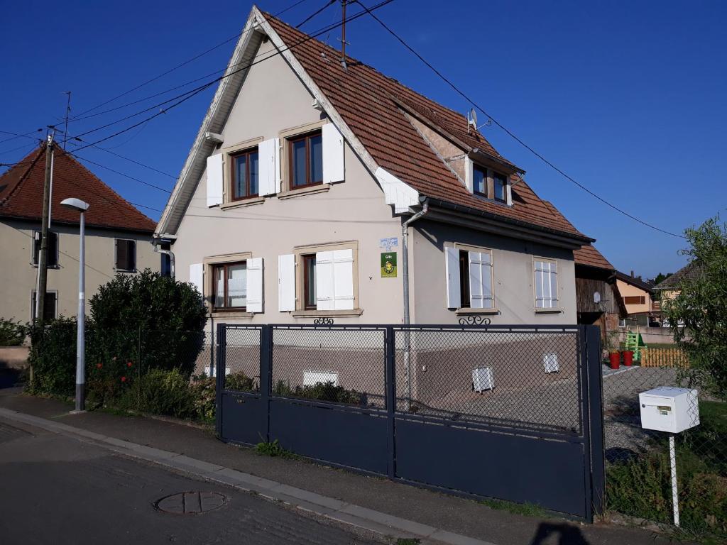 uma casa branca com uma cerca à frente. em 13 Rue de Sand em Matzenheim