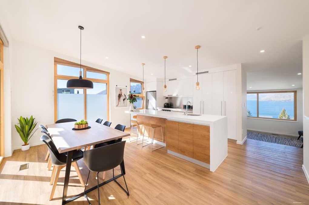 a kitchen and dining room with a table and chairs at The Lairds Bothy in Queenstown