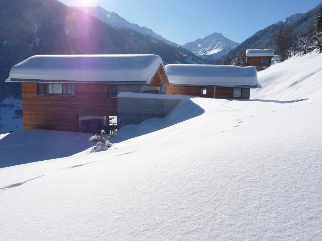 a building on a snow covered slope in front at Chalet E Toue in Nendaz