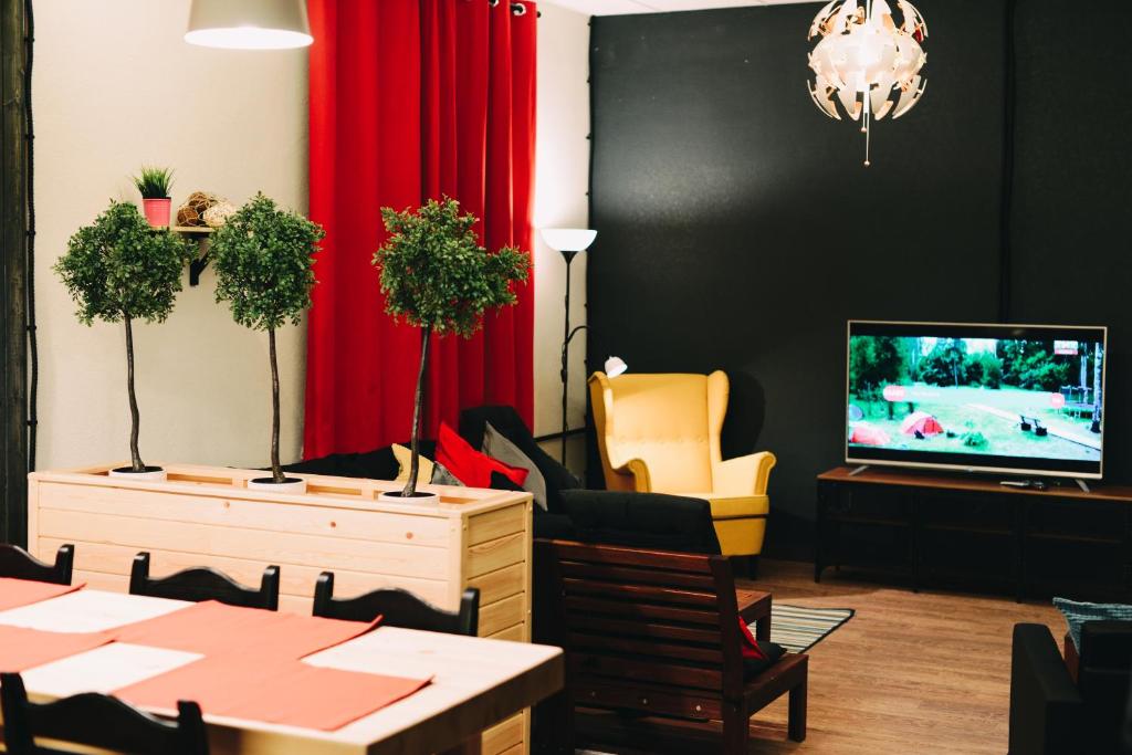 a dining room with a television and a table and chairs at Good Night rooms & hostel in Murmansk