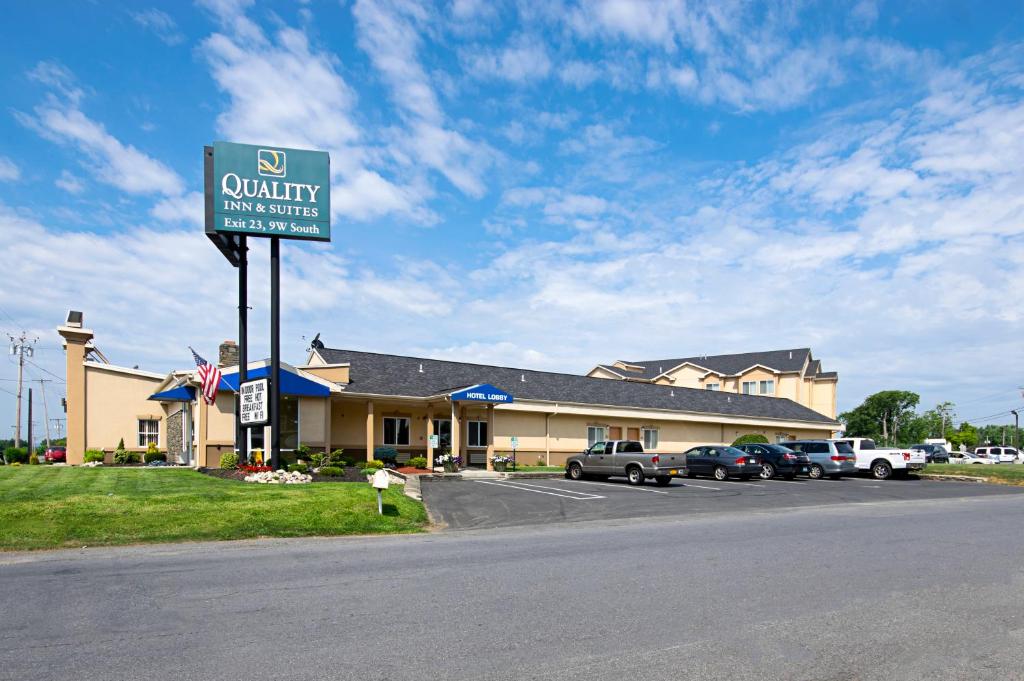 una señal frente a un hotel con coches aparcados delante en Quality Inn & Suites Glenmont - Albany South en Glenmont