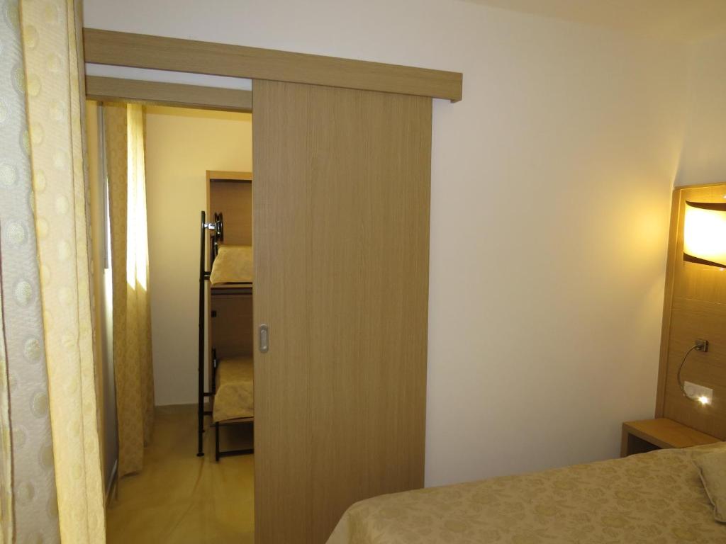 Postel nebo postele na pokoji v ubytování Hôtel Mare E Monti