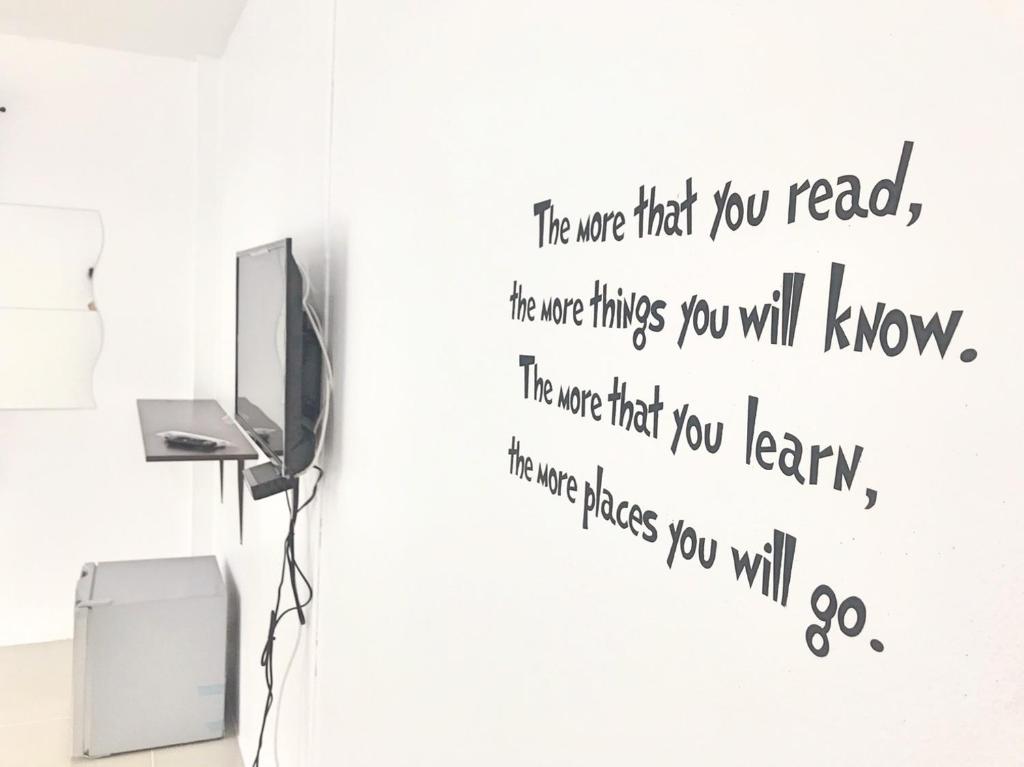 a wall sticker in a room with a tv at Rest Point Sampran in Nakhon Pathom