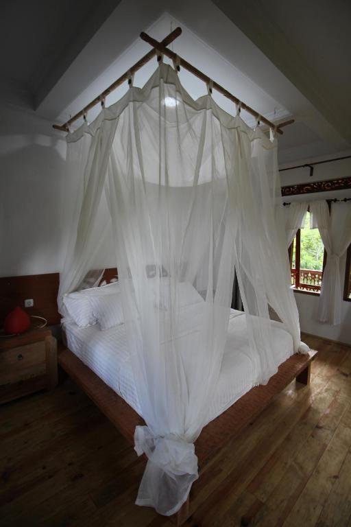 Postel nebo postele na pokoji v ubytování Padi Ecolodge