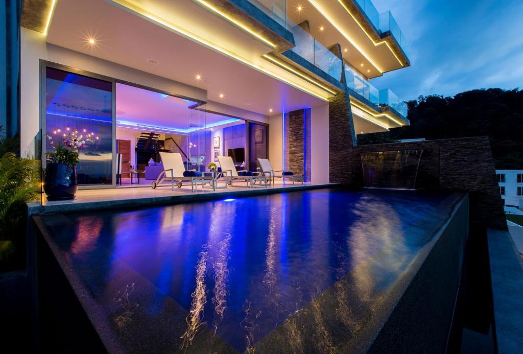 a swimming pool in the backyard of a house at night at Villa Momo Private Pool near Kata Beach in Kata Beach