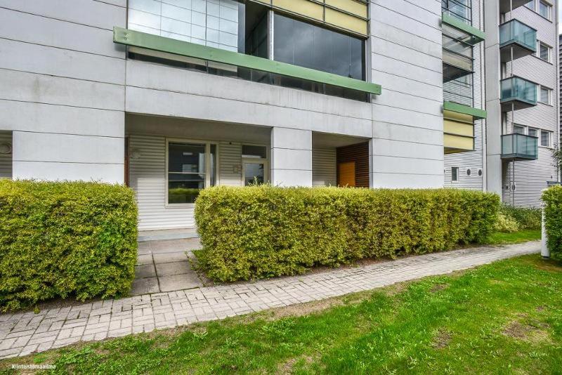 a building with bushes in front of a building at Lomaosake Meritullinraitti 1 B20 in Oulu