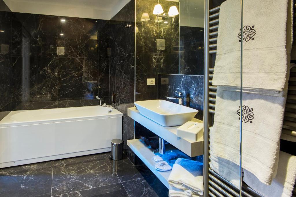 a bathroom with a tub and a sink and a shower at Mediterraneo Emotional Hotel & Spa in Santa Margherita Ligure