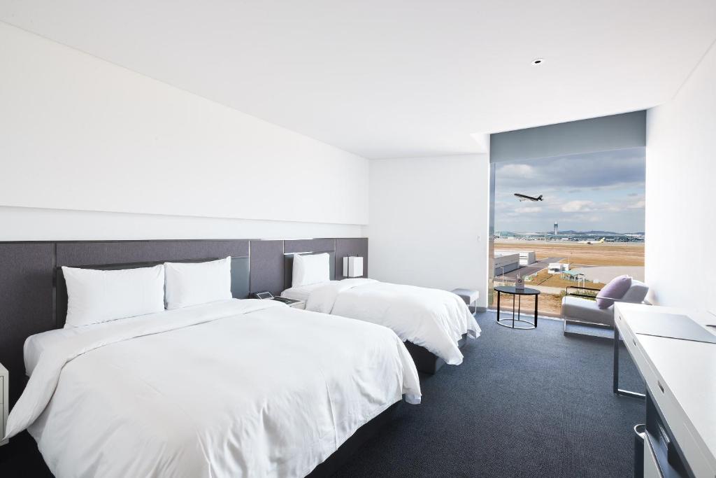 Postel nebo postele na pokoji v ubytování Hotel Ora Incheon