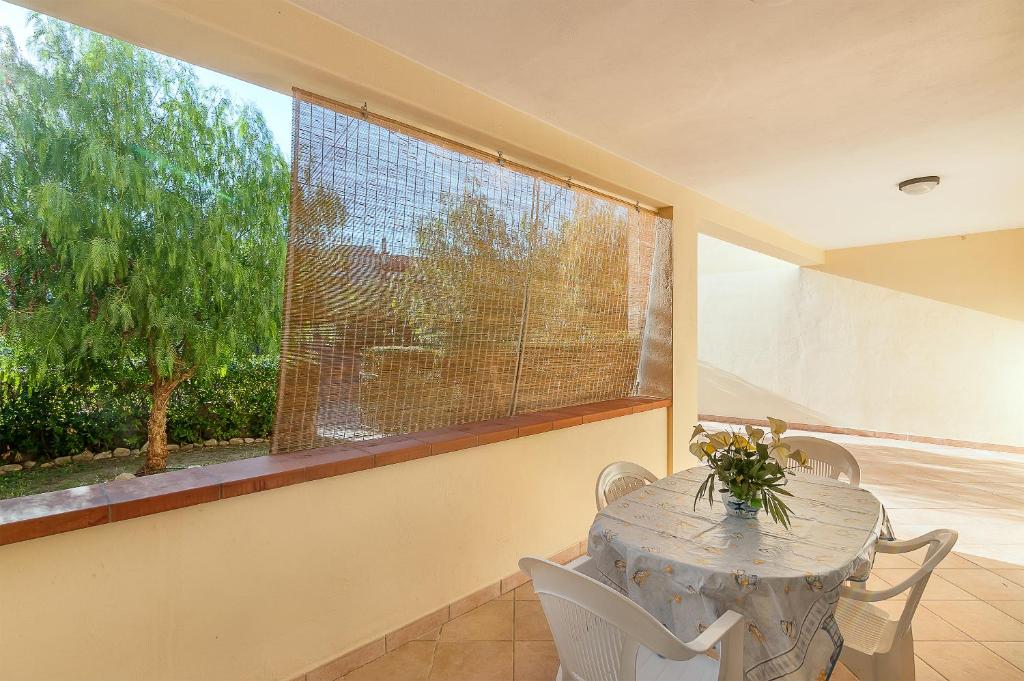 a table and chairs in a room with a window at Salice in Marina di Campo