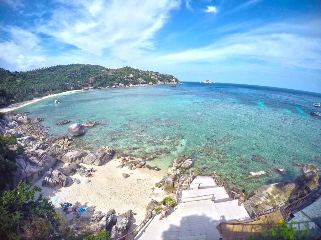 an aerial view of a beach with rocks and the ocean at Taatoh Seaview Resort - SHA Plus in Koh Tao