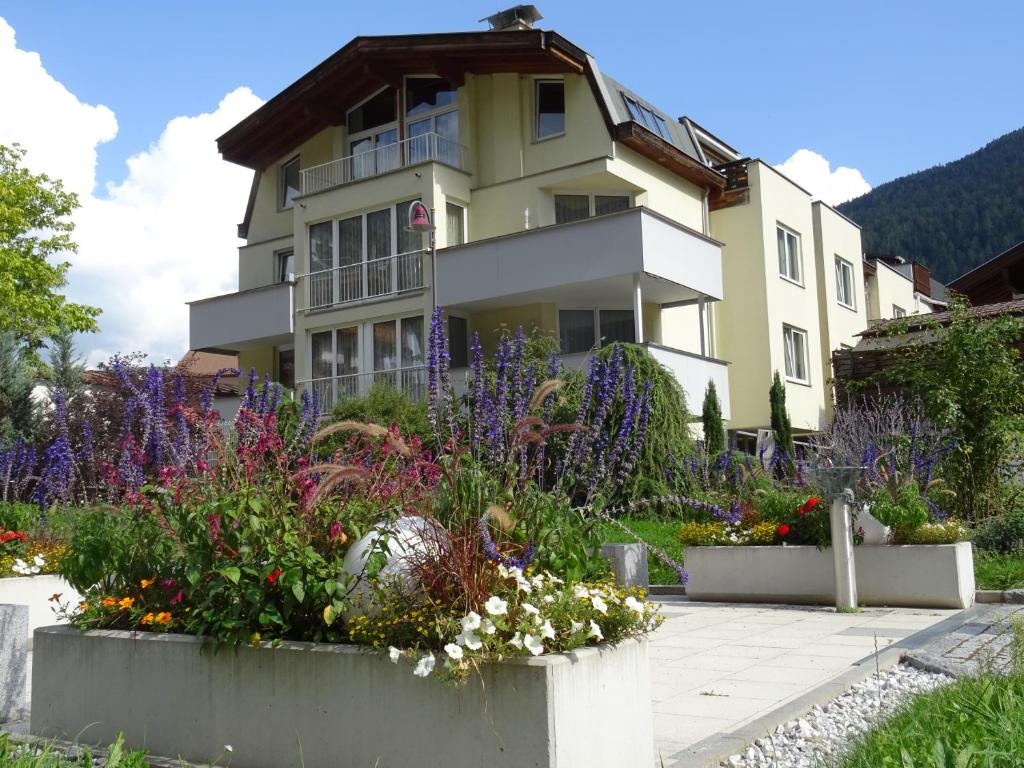 ein Haus mit Blumen davor in der Unterkunft Appartements am Kirchplatz in Fulpmes