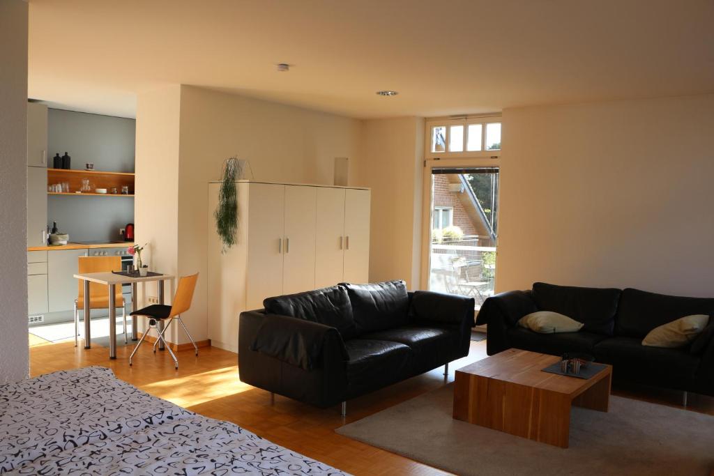 a living room with a couch and a table at Weeze in Bedburg Hau