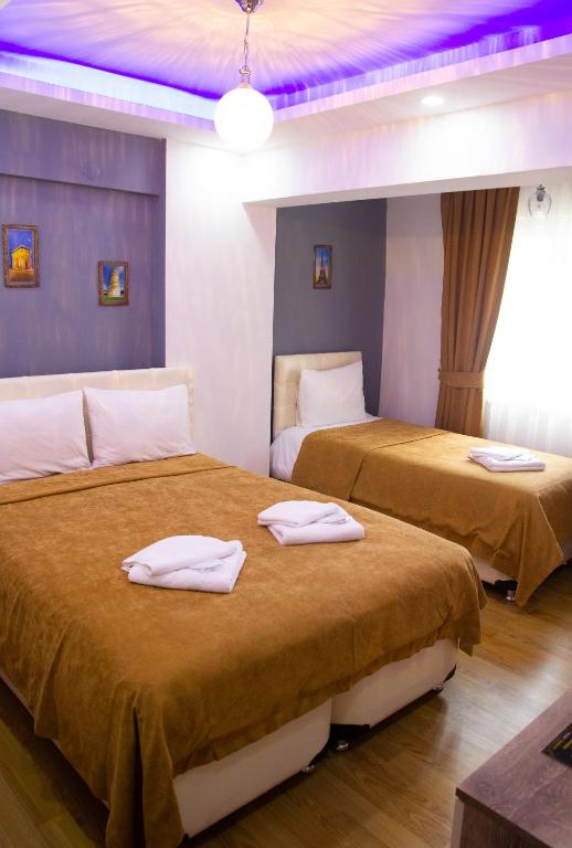 Postel nebo postele na pokoji v ubytování Figen Hotel