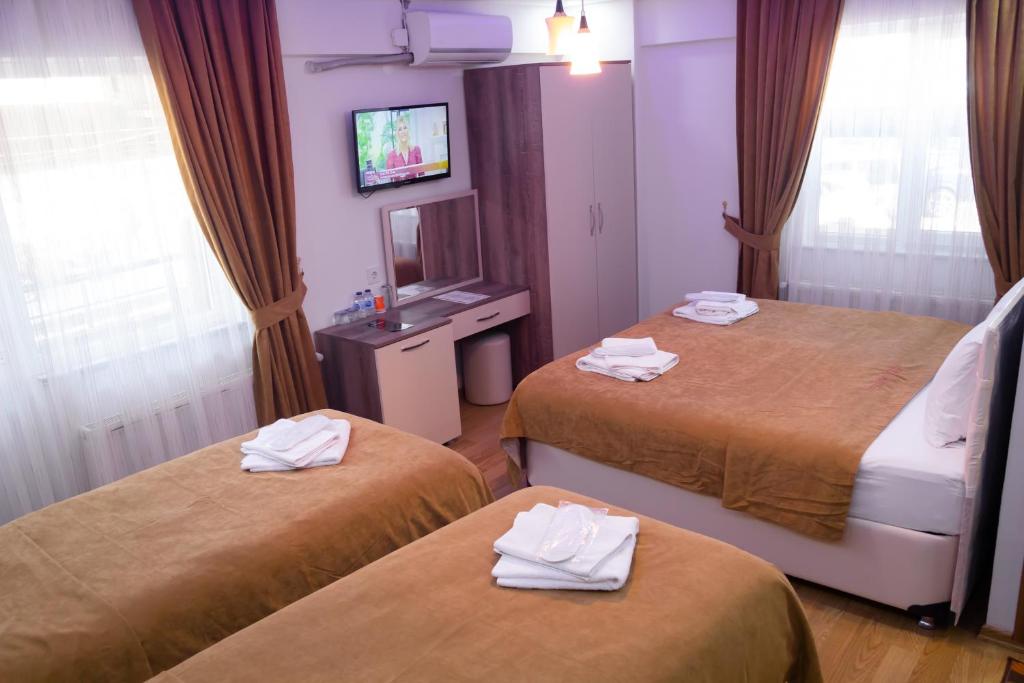 Postel nebo postele na pokoji v ubytování Figen Hotel