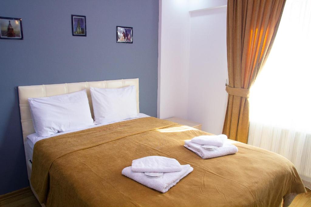 Postel nebo postele na pokoji v ubytování Figen Hotel