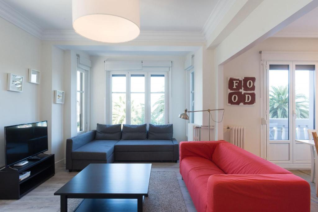 a living room with a couch and a table at Atlantic - Iberorent Apartments in San Sebastián