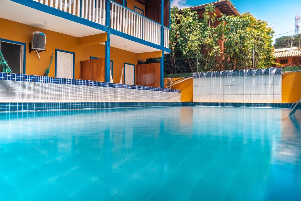 a swimming pool in front of a house at Brisa do Caitá Praia Hotel in Morro de São Paulo