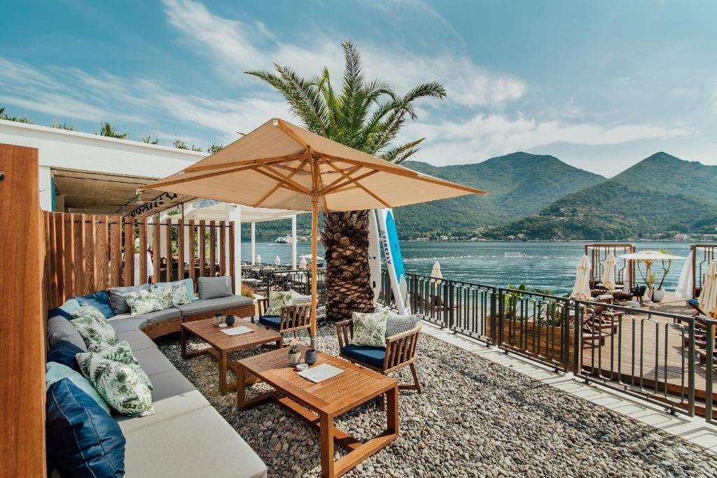 patio con divano e ombrellone di Boutique Hotel & Spa Casa del Mare - Mediterraneo a Herceg-Novi