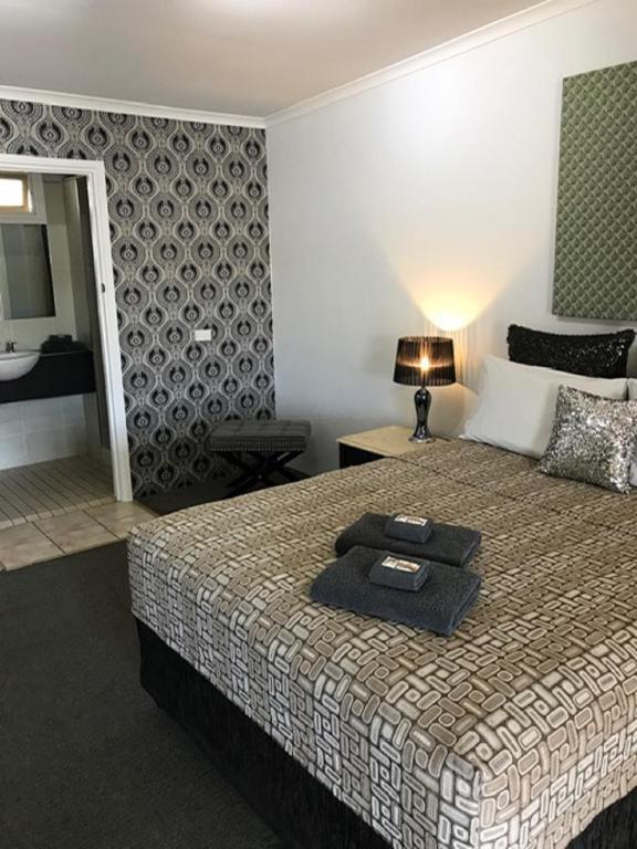 Postel nebo postele na pokoji v ubytování Central Motel Gin Gin