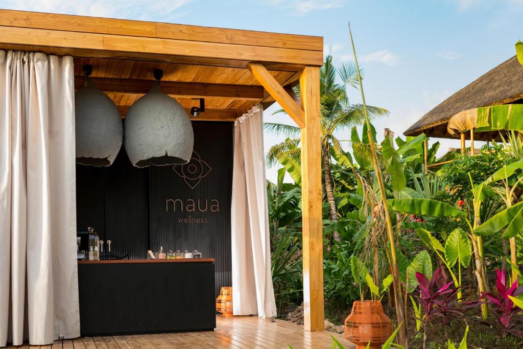 a bar at a resort with a canopy and plants at Zuri Zanzibar in Kendwa