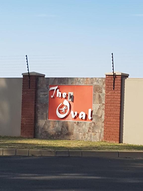 a sign on the side of a brick building at The Coral Door in Vereeniging