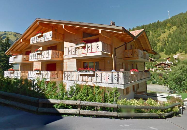 a house with white balconies on the side of it at Le Charme 9 in Morgins