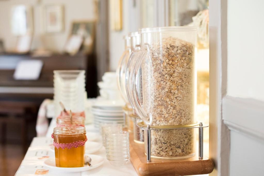 a blender filled with granola and a jar of honey at Hotel Villa Rivoli in Nice