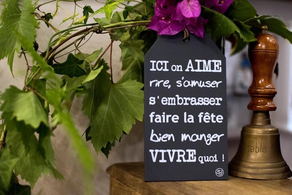 a vase with a sign on it next to a plant at Hotel Villa Rivoli in Nice