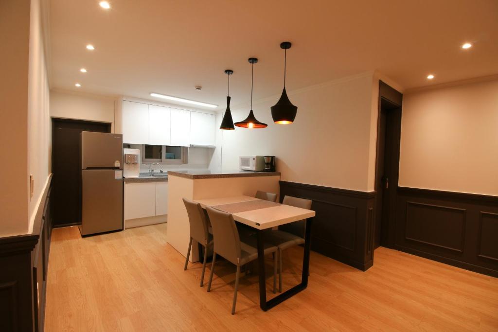 a kitchen with a table and a counter top at Heima Guesthouse Hongdae in Seoul