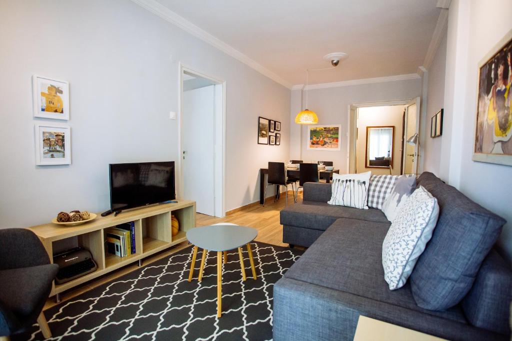 a living room with a couch and a tv at Luxurious & Modern | Walk Everywhere | 5★ Amenities in Thessaloniki