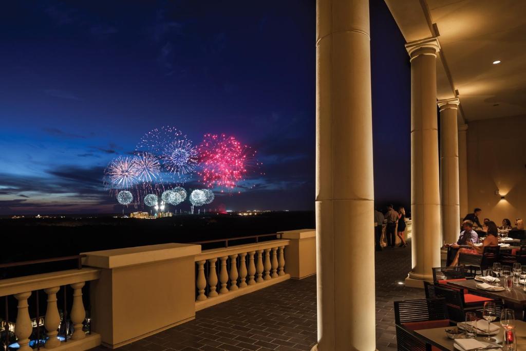 a restaurant with a view of fireworks at night at Four Seasons Resort Orlando at Walt Disney World Resort in Orlando
