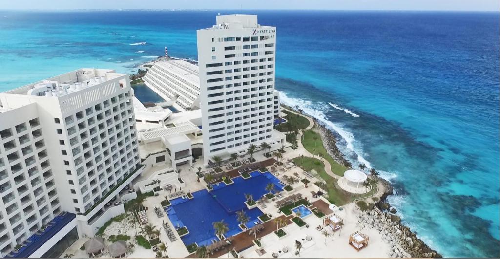 a large body of water with a large building at Turquoize at Hyatt Ziva Cancun - Adults Only - All Inclusive in Cancún