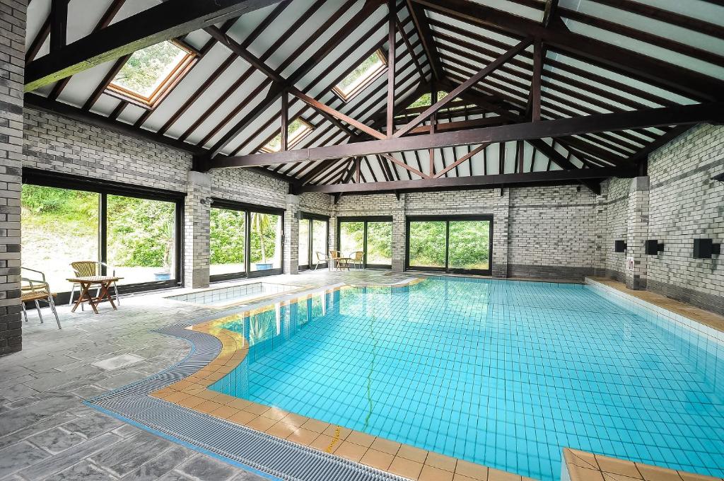 a large swimming pool with a large ceiling at Corffe House and Holiday Cottages in Barnstaple