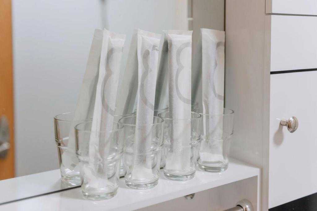 a group of glass vases sitting on a shelf at Xi’an Beilin·Moslem Street (Huimin Jie)· Locals Apartment 00174500 in Xi'an