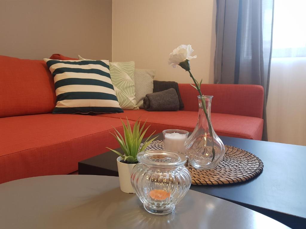 a vase with a flower in it sitting on a table at Radomir Downtown Apartments in Radomir