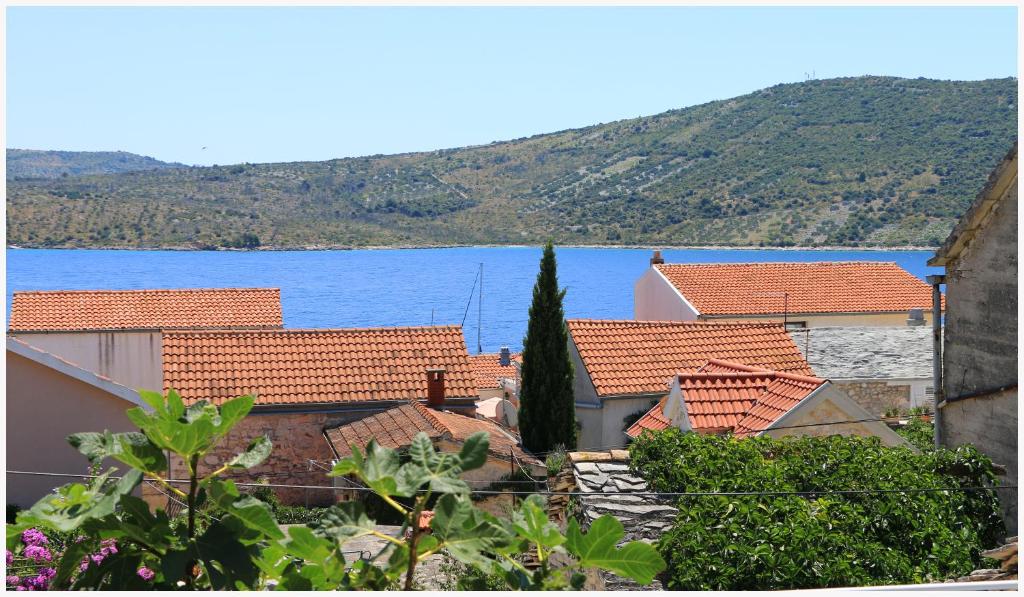 a group of houses with a lake in the background at Holiday Home Ante in Primošten