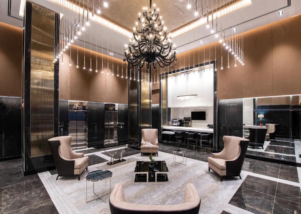 a salon with chairs and a chandelier at Aliz Hotel Times Square in New York