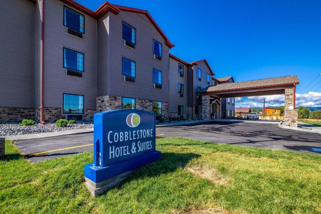 a hotel sign in front of a building at Cobblestone Hotel & Suites - Victor in Victor