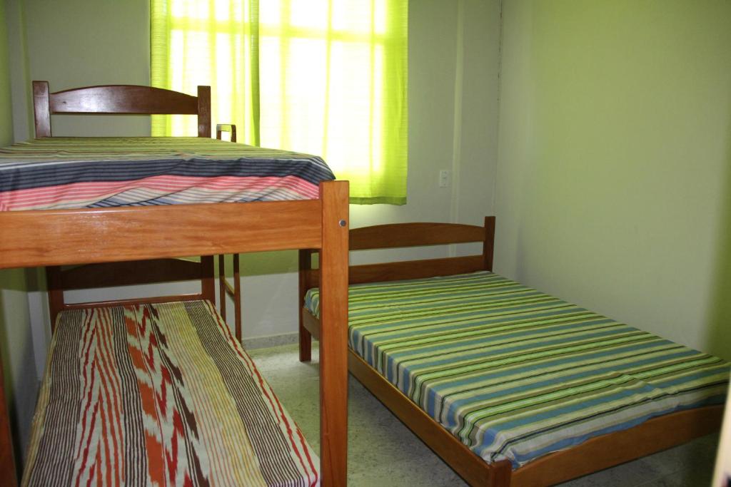 a bedroom with two bunk beds and a window at Edifício San Jorge in Piúma