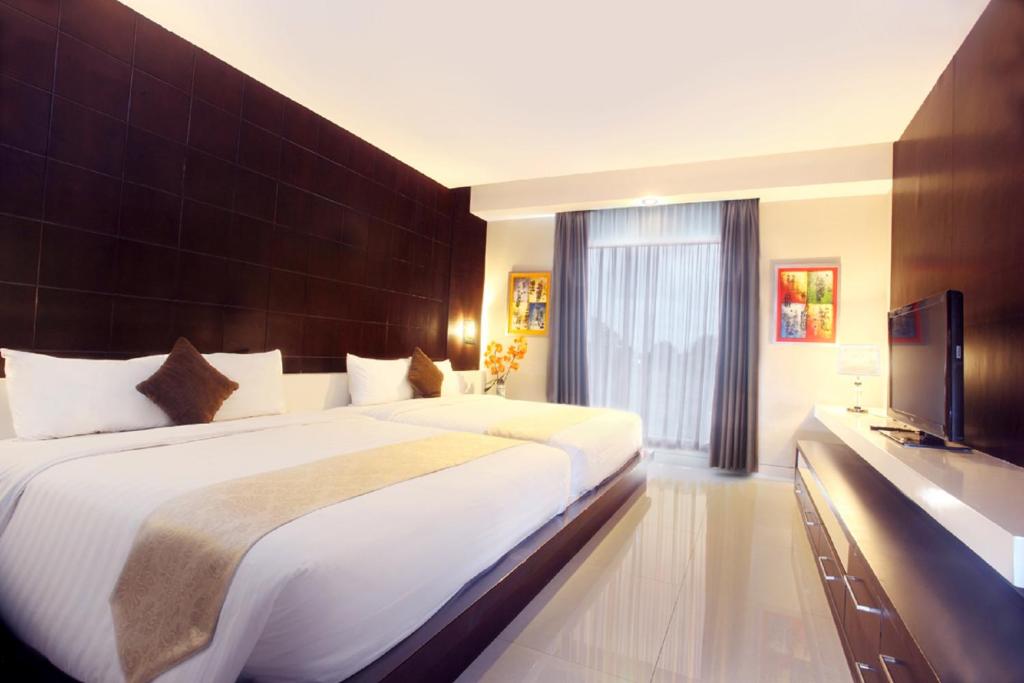 Postel nebo postele na pokoji v ubytování Grand Hatika Hotel
