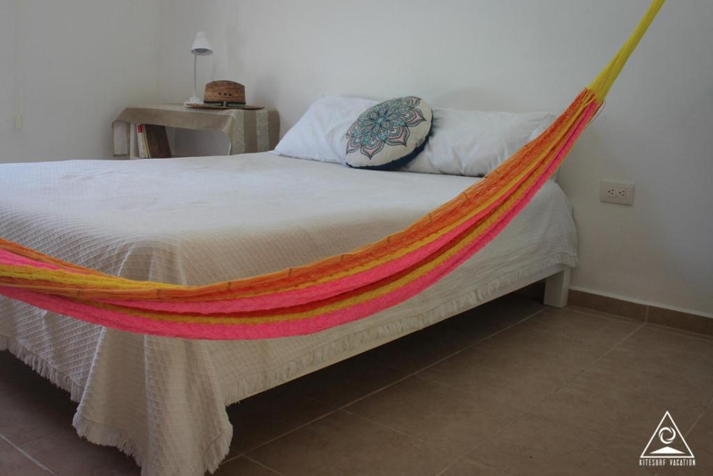a bed with a hammock on it in a room at CASA KINICH SISAL in Sisal