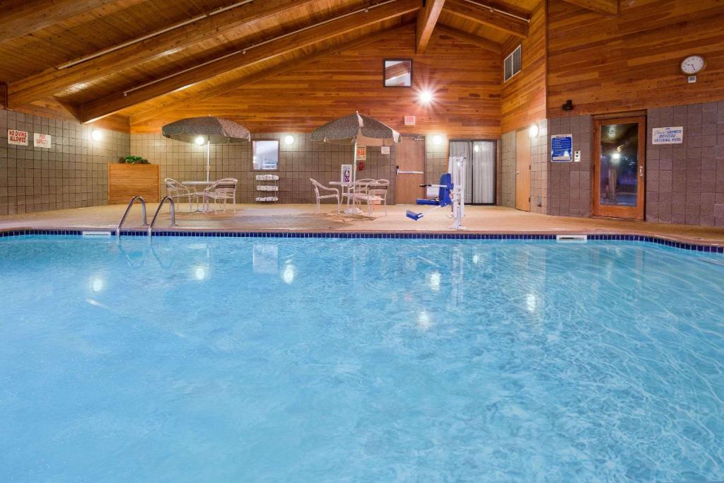 a large swimming pool in a hotel room at AmericInn by Wyndham Coon Rapids in Coon Rapids