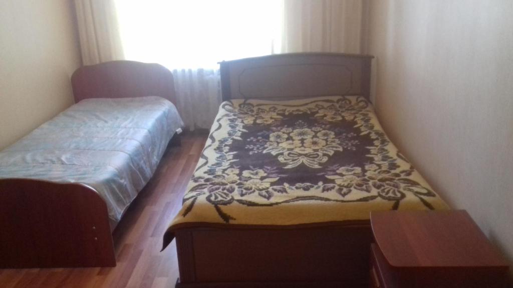 Кровать или кровати в номере Prospekt Pobedy, 1